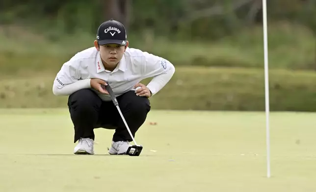 Liqi Zeng, of China, lines up her shot on the seventh hole during the first round of the LPGA Walmart NW Arkansas Championship golf tournament, Friday, Sept. 27, 2024, in Rogers, Ark. (AP Photo/Michael Woods)