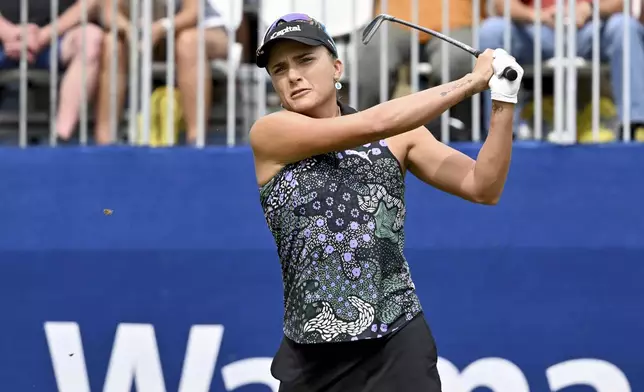 Lexi Thompson watches her shot off the first tree during the first round of the LPGA Walmart NW Arkansas Championship golf tournament, Friday, Sept. 27, 2024, in Rogers, Ark. (AP Photo/Michael Woods)