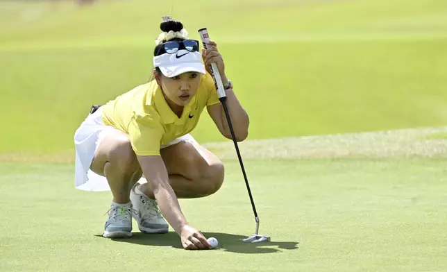 Lucy Li, of the United States, lines up her shot on the 17th hole during the final round of the LPGA Walmart NW Arkansas Championship golf tournament, Sunday, Sept. 29, 2024, in Rogers, Ark. (AP Photo/Michael Woods)