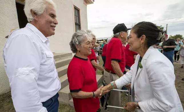 Secretary of the Interior Deb Haaland, right, congratulates alumni Betty Nuñez Aguirre, center, and Tony Cano during the inauguration of Blackwell School as the newest National Historic Site in Marfa, Texas, Saturday, Sept. 14, 2024. (AP Photo/Andres Leighton)