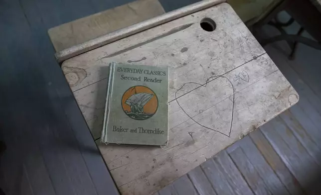 An old book rests on a desk of the Blackwell School classroom pictured during the school inauguration as the newest National Historic Site in Marfa, Texas, Saturday, Sept. 14, 2024. (AP Photo/Andres Leighton)