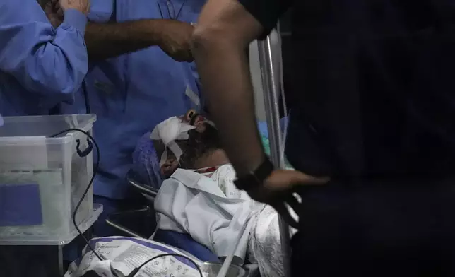 A man who was injured in the explosion of one of the handheld devices, lies inside an operation room ahead of an eye surgery at the Eye Specialist hospital, in Beirut, Lebanon, Friday, Sept. 20, 2024. (AP Photo/Hussein Malla)