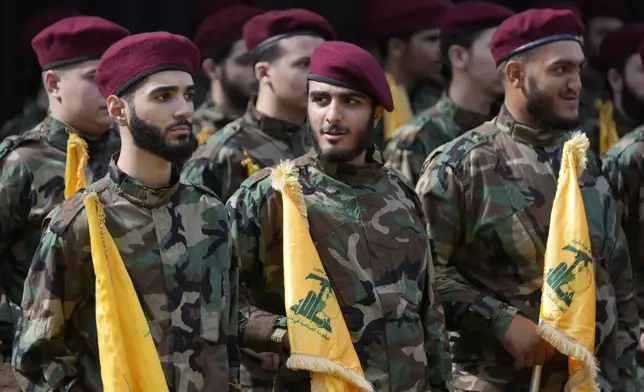 Hezbollah members attend the funeral of two of their comrades who were killed on Wednesday when a handheld device exploded, during a funeral procession in the southern suburbs of Beirut, Thursday, Sept. 19, 2024. (AP Photo/Hussein Malla)