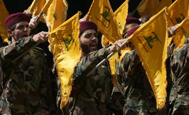 Hezbollah members attend the funeral of two of their comrades who were killed on Wednesday when a handheld device exploded, during a funeral procession in the southern suburbs of Beirut, Thursday, Sept. 19, 2024. (AP Photo/Hussein Malla)