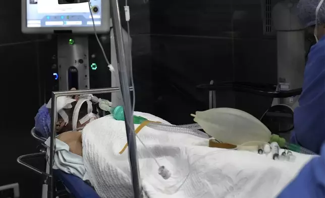 A man who was injured in the explosion of one of the handheld devices, lies inside an operation room ahead of an eye surgery at the Eye Specialist hospital, in Beirut, Lebanon, Friday, Sept. 20, 2024. (AP Photo/Hussein Malla)