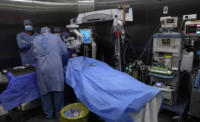 Doctors make an eye surgery operation on a man who was injured in the explosion of one of the handheld devices, at the Eye Specialist hospital, in Beirut, Lebanon, Friday, Sept. 20, 2024. (AP Photo/Hussein Malla)