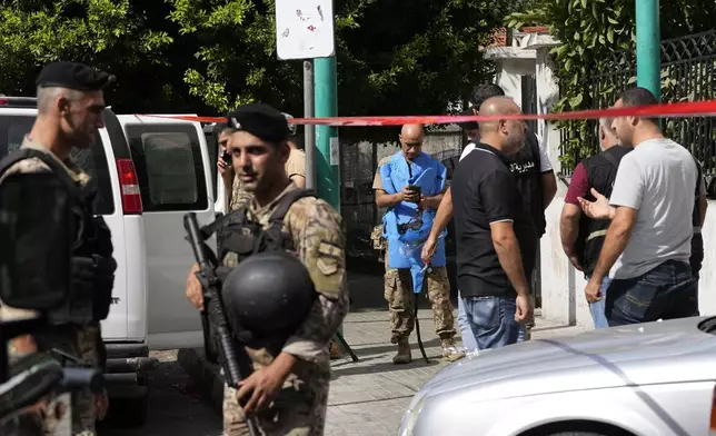 Police tape cordons off the area as security members and an explosive specialist investigate a suspicious device in Beirut, Thursday, Sept. 19, 2024. (AP Photo/Hassan Ammar)