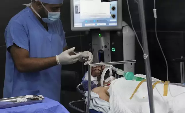 A man who was injured in the explosion of one of the handheld devices, lies inside an operation room ahead of an eye surgery at the Eye Specialist hospital, in Beirut, Lebanon, Friday, Sept. 20, 2024. (AP Photo/Hussein Malla)