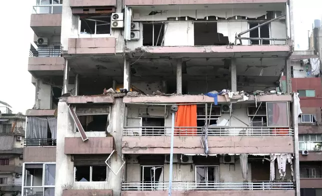 Damages are seen on a building that was hit by Israeli strike, early Monday, Sept. 30, 2024. (AP Photo/Hussein Malla)