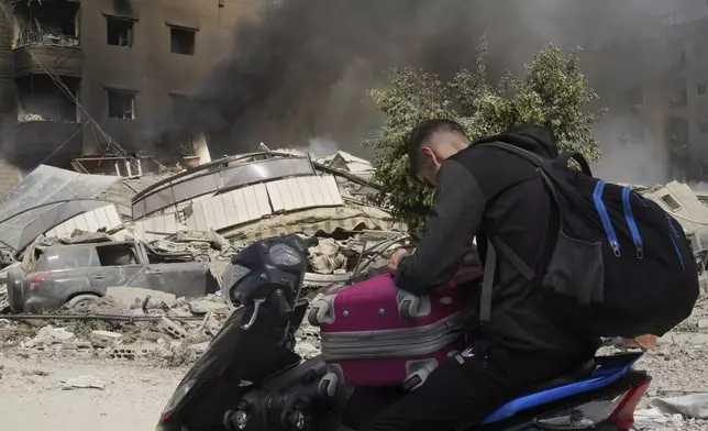 Smoke rises from Israeli airstrikes in Beirut's southern suburbs, Saturday, Sept. 28, 2024. (AP Photo/Hussein Malla)