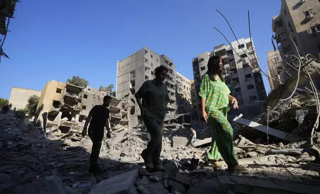 People check the site of the assassination of Hezbollah leader Hassan Nasrallah in Beirut's southern suburbs, Sunday, Sept. 29, 2024. (AP Photo/Hassan Ammar)