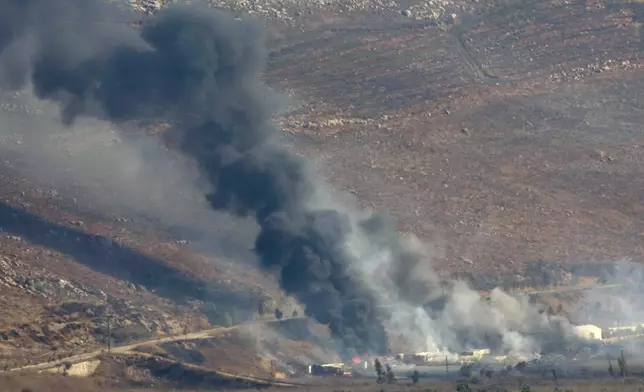 Flame and smoke rise from an Israeli airstrike in the Khiam valley, as seen from Marjayoun town, south Lebanon, Tuesday, Sept. 24, 2024. (AP Photo/Hussein Malla)