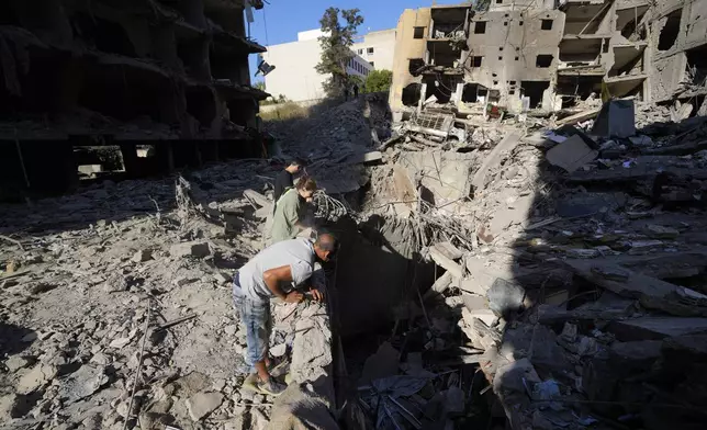 People check the site of the assassination of Hezbollah leader Hassan Nasrallah in Beirut's southern suburbs, Sunday, Sept. 29, 2024. (AP Photo/Hassan Ammar)