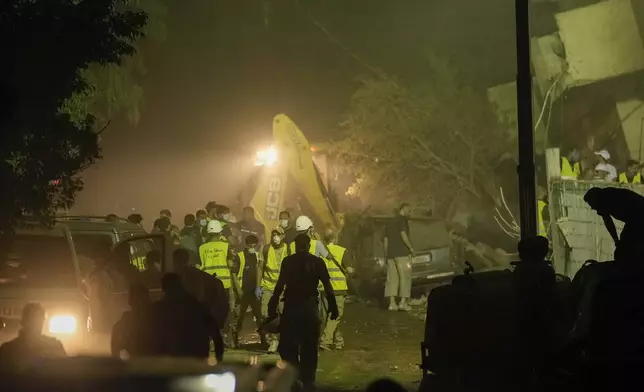 Rescuers arrive at the site of an Israeli airstrike in Beirut's southern suburbs Friday, Sept. 27, 2024. (AP Photo/Bilal Hussein)