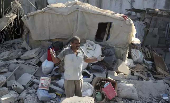 A man reacts as he stands on the rubble of a building hit in an Israeli airstrike in the southern village of Akbieh, Lebanon, Tuesday, Sept. 24, 2024. (AP Photo/Mohammed Zaatari)