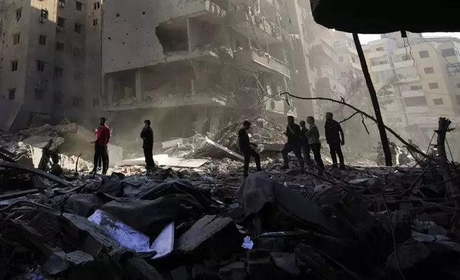 People check the site of the assassination of Hezbollah leader Hassan Nasrallah in Beirut's southern suburbs, Sunday, Sept. 29, 2024. (AP Photo/Hassan Ammar)