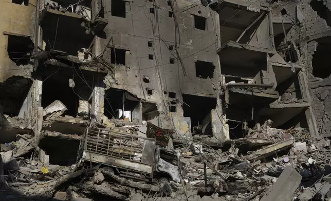 Crumbled buildings at the site of the assassination of Hezbollah leader Hassan Nasrallah in Beirut's southern suburbs, Sunday, Sept. 29, 2024. (AP Photo/Hassan Ammar)