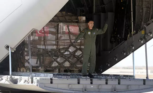 A Turkish Air Force personnel unloads medical aid boxes at Beirut airport, Wednesday, Sept. 25, 2024. (AP Photo/Bilal Hussein)