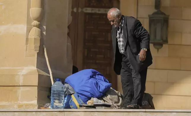 An elderly man stands near al-Amin Mosque in Beirut's Martyrs' square after fleeing the Israeli airstrikes in the southern suburbs of Dahiyeh, Sunday, Sept. 29, 2024. (AP Photo/Bilal Hussein)