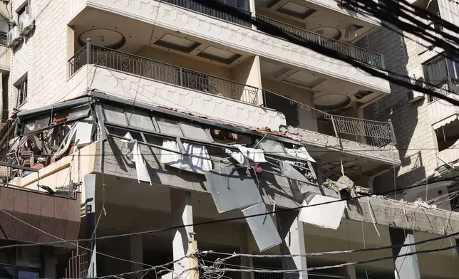 A damaged building at the site of an Israeli airstrike in Beirut's southern suburbs, Thursday, Sept. 26, 2024. (AP Photo/Hassan Ammar)