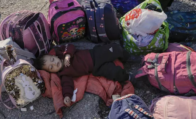 A child sleeps on the ground in Beirut's Martyrs' square after fleeing the Israeli airstrikes in the southern suburbs of Dahiyeh, Saturday, Sept. 28, 2024. (AP Photo/Bilal Hussein)