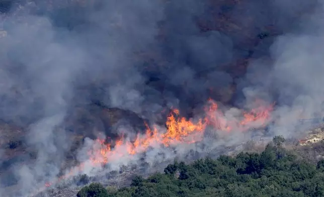 Flames and smoke rise from an Israeli airstrike on the Mahmoudieh mountain, as seen from Marjayoun town, south Lebanon, Tuesday, Sept. 24, 2024. (AP Photo/Hussein Malla)