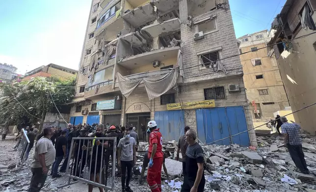 Rescuers arrive at the scene of an Israeli airstrike in Beirut's suburb of Ghobeiri, Sunday, Sept. 29, 2024. (AP Photo/Hussein Malla)