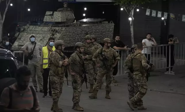 Lebanese soldiers secure the area near the site of an Israeli airstrike in Beirut's southern suburb, Monday, Sept. 23, 2024. (AP Photo/Bilal Hussein)