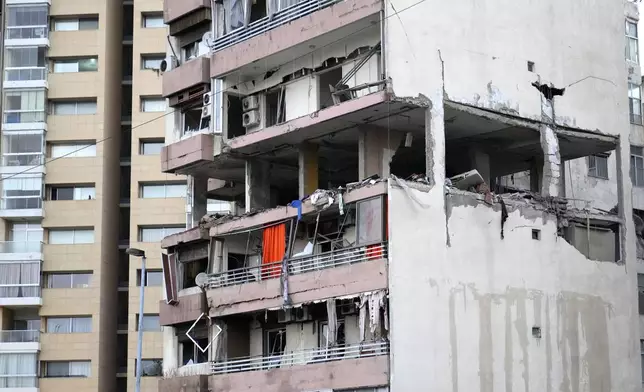 A damaged apartment is seen on a building that was hit by Israeli strike, in Beirut early Monday, Sept. 30, 2024. (AP Photo/Hussein Malla)