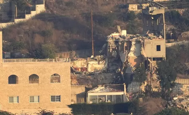 A destroyed house by an Israeli airstrike on Khiam village, as seen from Marjayoun town, south Lebanon, Tuesday, Sept. 24, 2024. (AP Photo/Hussein Malla)