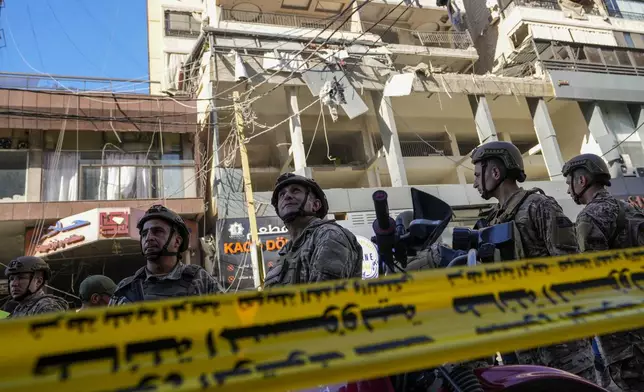 Lebanese soldiers cordon off the area at the site of an Israeli airstrike in Beirut's southern suburbs, Thursday, Sept. 26, 2024. (AP Photo/Hassan Ammar)