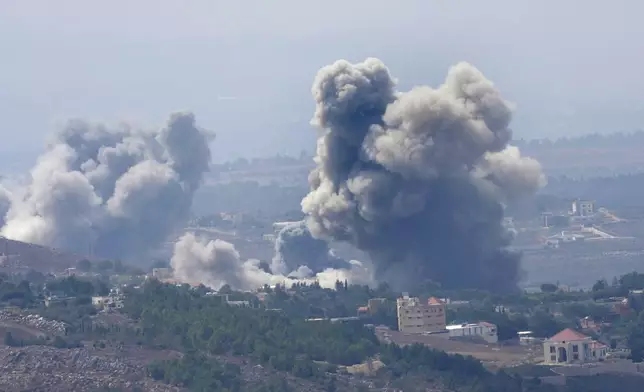 Smoke rises from Israeli airstrikes on villages in the Nabatiyeh district, seen from the southern town of Marjayoun, Lebanon, Monday, Sept. 23, 2024. (AP Photo/Hussein Malla)