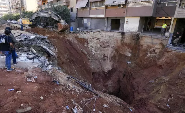 A hole in the ground near the site of the assassination of Hezbollah leader Hassan Nasrallah in Beirut's southern suburbs, Sunday, Sept. 29, 2024. (AP Photo/Hassan Ammar)