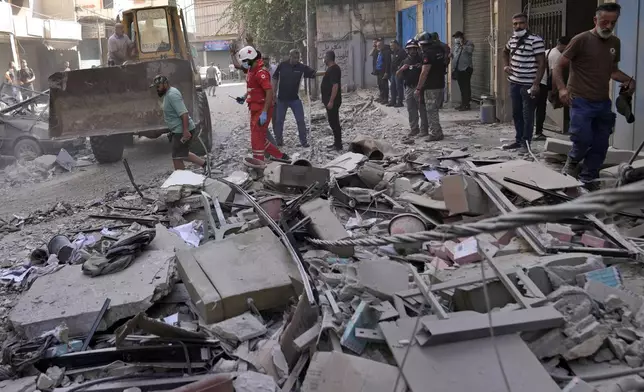 Rescuers arrive at the scene of an Israeli airstrike in Beirut's suburb of Ghobeiri, Sunday, Sept. 29, 2024. (AP Photo/Hussein Malla)