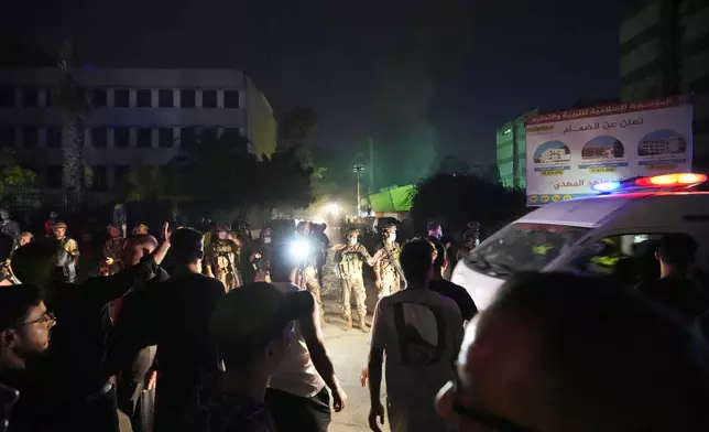 Rescuers arrive near the site of an Israeli airstrike in Beirut's southern suburbs, Friday, Sept. 27, 2024. (AP Photo/Hassan Ammar)