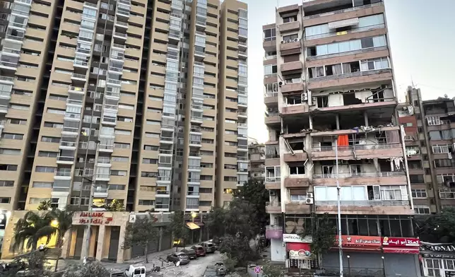 Damaged apartments, right, are seen in a building that was hit by Israeli strike, in Beirut, Lebanon, early Monday, Sept. 30, 2024. (AP Photo/Hussein Malla)