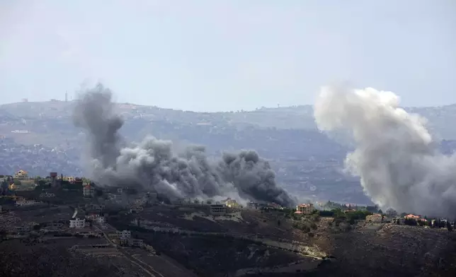 Smoke rises from Israeli airstrikes on Taybeh village, seen from the southern town of Marjayoun, Lebanon, Monday, Sept. 23, 2024. (AP Photo/Hussein Malla)