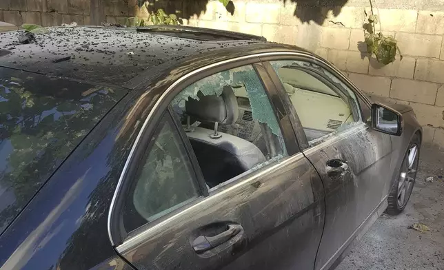 A partly damaged car after what is believed to be the result of a walkie-talkie exploding inside it, in the southern port city of Sidon, Lebanon, Wednesday, Sept. 18, 2024. (AP Photo/Mohammed Zaatari)