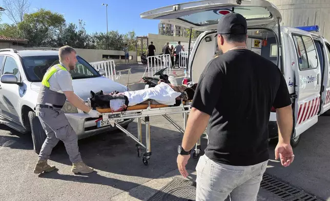 Civil Defense first-responders carry a wounded man whose handheld pager exploded at al-Zahraa hospital in Beirut, Lebanon, Tuesday, Sept. 17, 2024. (AP Photo/Hussein Malla)