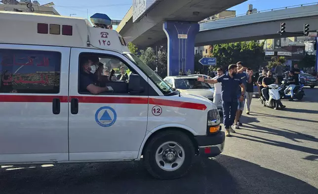 An ambulance carries wounded people whose handheld pager exploded, in Beirut, Lebanon, Tuesday, Sept. 17, 2024. (AP Photo/Hassan Ammar)