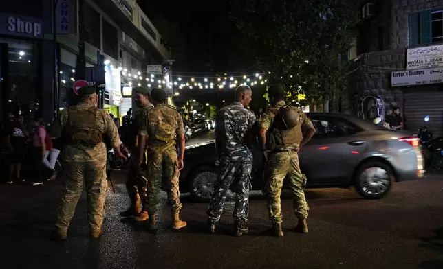 Lebanese soldiers stand guard at a street that leads to the American University hospital where they bring wounded people whose handheld pager exploded, in Beirut, Lebanon, Tuesday, Sept. 17, 2024. (AP Photo/Hassan Ammar)