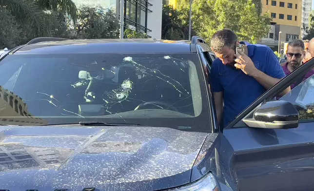 Police officers inspect a car inside of which a hand-held pager exploded, Beirut, Lebanon, Tuesday, Sept. 17, 2024. (AP Photo/Hussein Malla)