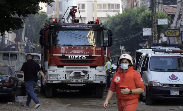 Rescuers at the scene a day after an Israeli missile strike in Beirut's southern suburbs, Saturday, Sept. 21, 2024. (AP Photo/Bilal Hussein)