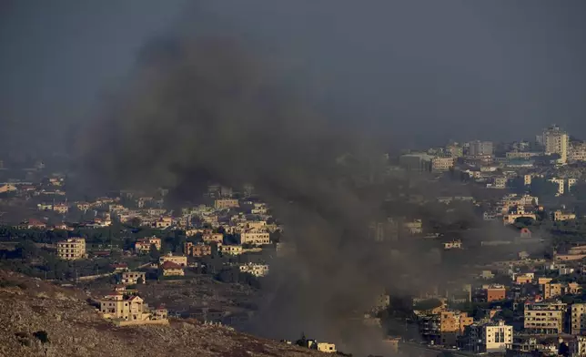 Smoke rises from an Israeli airstrike on Kfar Rouman village, as seen from Marjayoun town, south Lebanon, Monday, Sept. 23, 2024. (AP Photo/Hussein Malla)