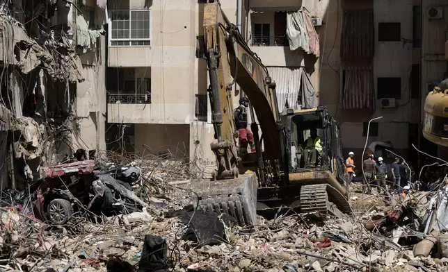 Emergency workers clear the rubble at the site of Friday's Israeli strike in Beirut's southern suburb, Sunday, Sept. 22, 2024. (AP Photo/Bilal Hussein)