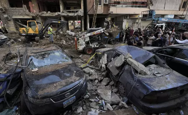 Damaged cars at the site of Friday's Israeli strike in Beirut's southern suburbs, Saturday, Sept. 21, 2024. (AP Photo/Bilal Hussein)