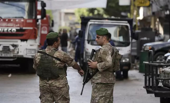 Lebanese soldiers stand guard near the site of Friday's Israeli strike in Beirut's southern suburb, Sunday, Sept. 22, 2024. (AP Photo/Bilal Hussein)