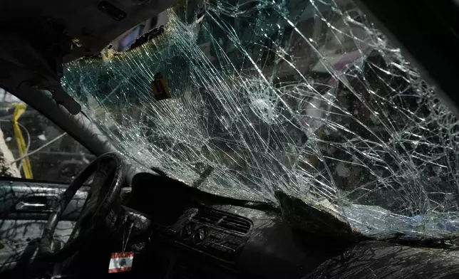 The shattered window of a car at the site of Friday's Israeli strike in Beirut's southern suburb, Sunday, Sept. 22, 2024. (AP Photo/Bilal Hussein)