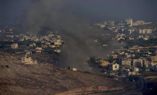 Smoke rises from an Israeli airstrike on Kfar Rouman village, as seen from Marjayoun town, south Lebanon, Monday, Sept. 23, 2024. (AP Photo/Hussein Malla)