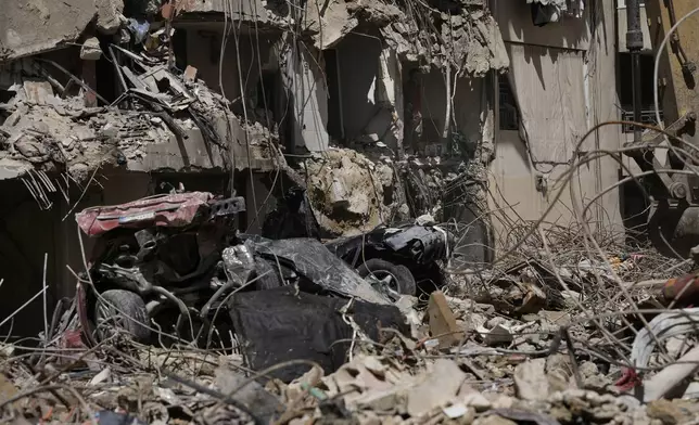 An emergency worker speaks on the phone during rescue efforts at the site of Friday's Israeli strike in Beirut's southern suburb, Sunday, Sept. 22, 2024. (AP Photo/Bilal Hussein)